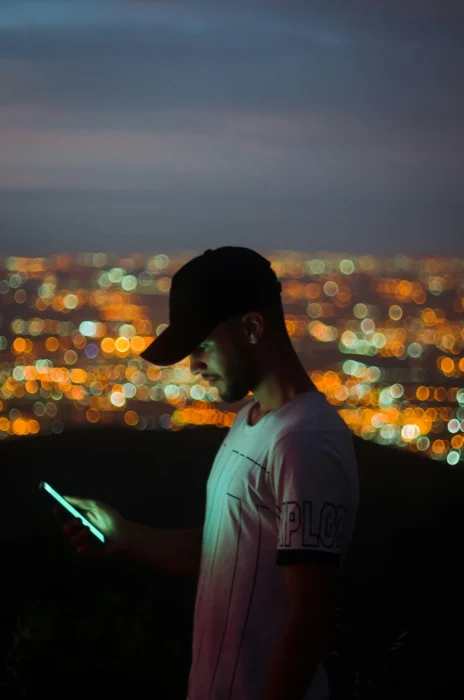 Photo of man looking at photos of his estranged dad that is non-death grief