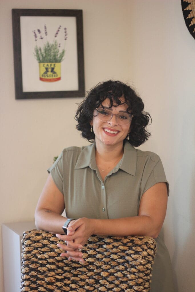 Person with curly hair indoors.