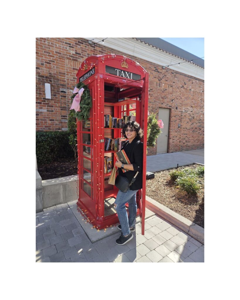 Woman and Red telephone booth with books
